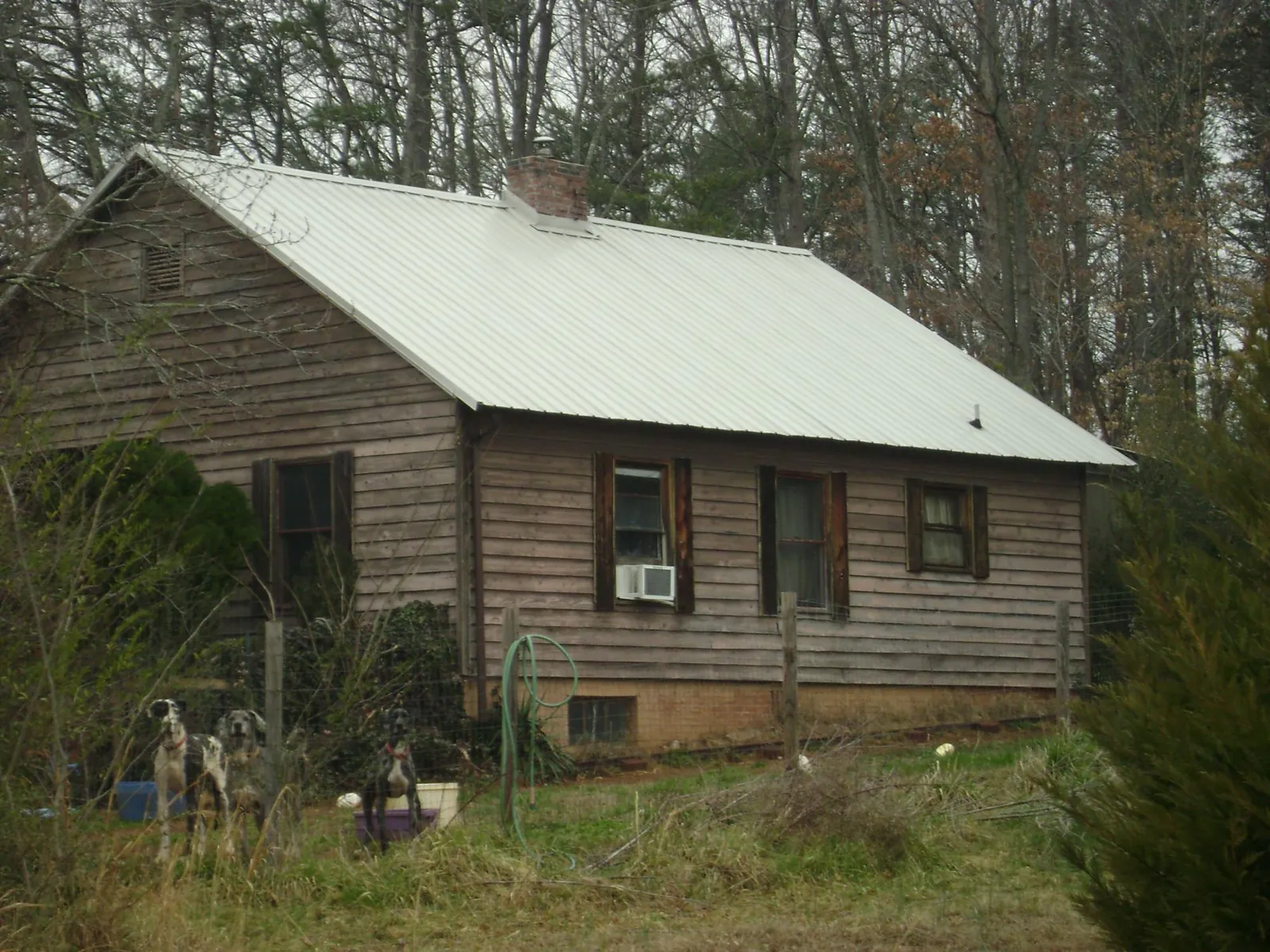 White metal roof on an old wood sided farmhouse, from a Metal Roof Installation job in Lee
